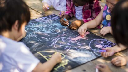 Children writing with chalk.