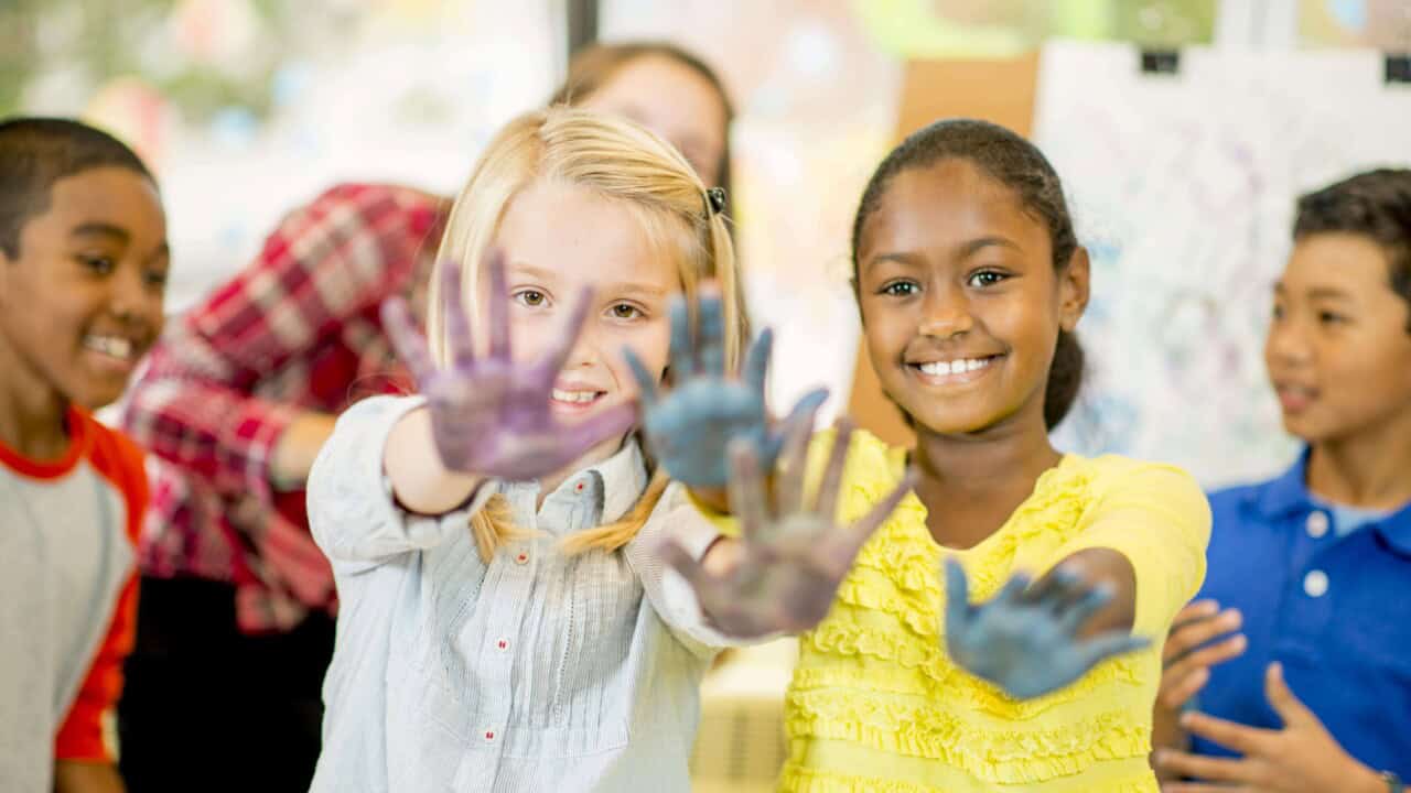 Two girls showing off their painted hands.