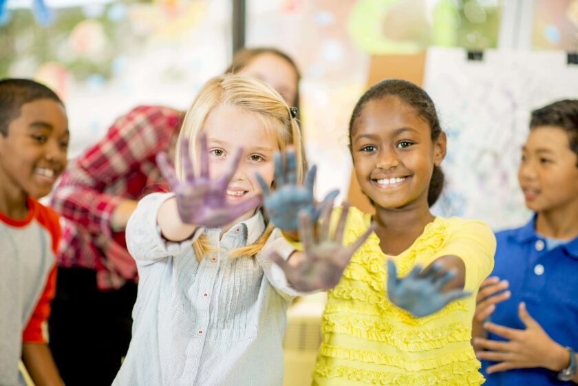 Two girls showing off their painted hands.